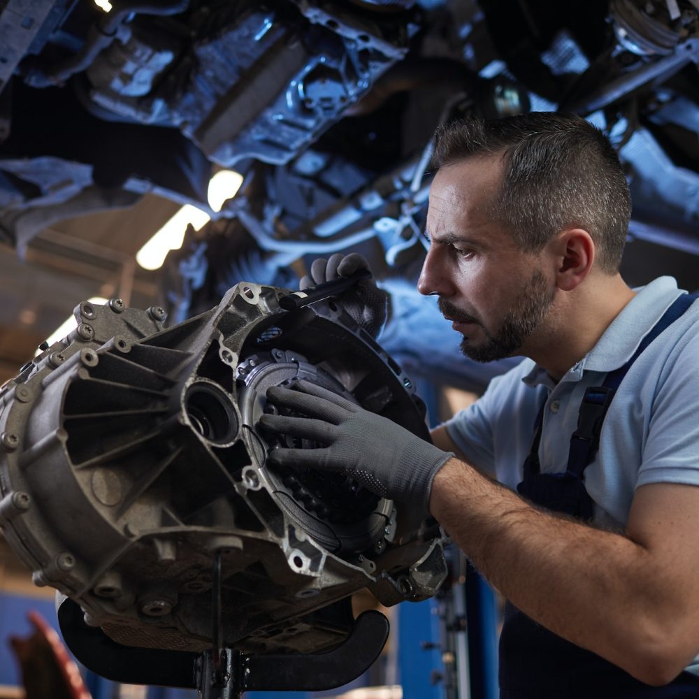 Auto Mechanic Fixing Car on Lift